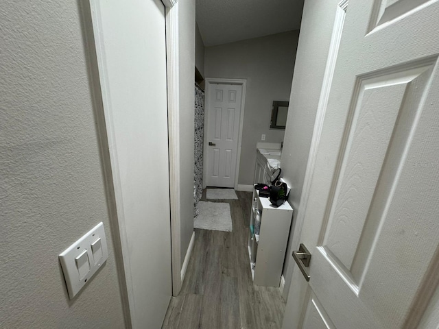 corridor with light hardwood / wood-style flooring