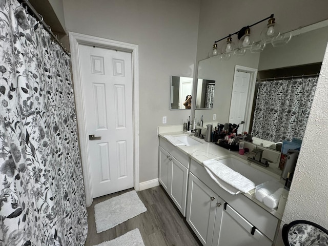 bathroom with wood-type flooring, vanity, and a shower with curtain