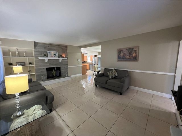 living room with a tile fireplace and light tile patterned floors