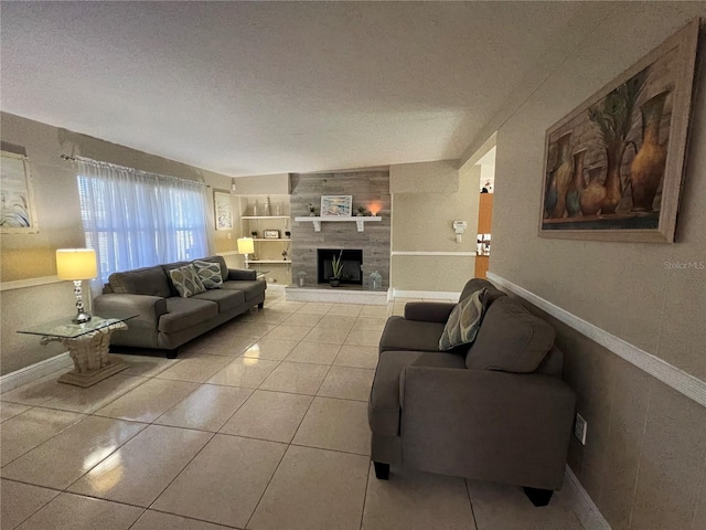 tiled living room with a tiled fireplace and a textured ceiling