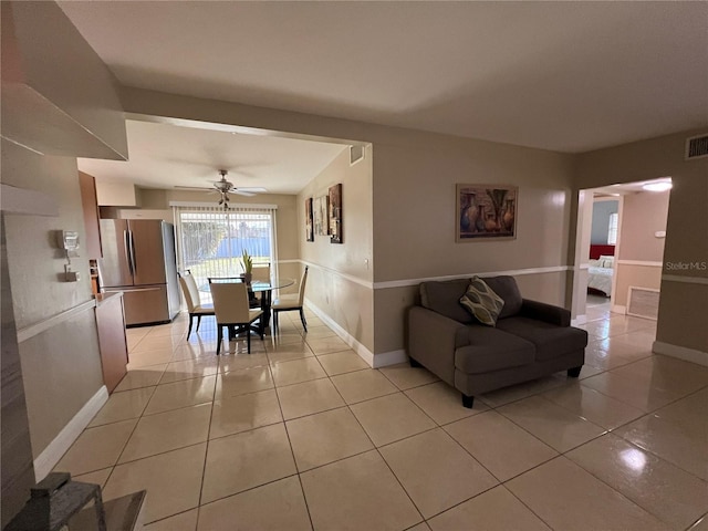 tiled dining room featuring ceiling fan