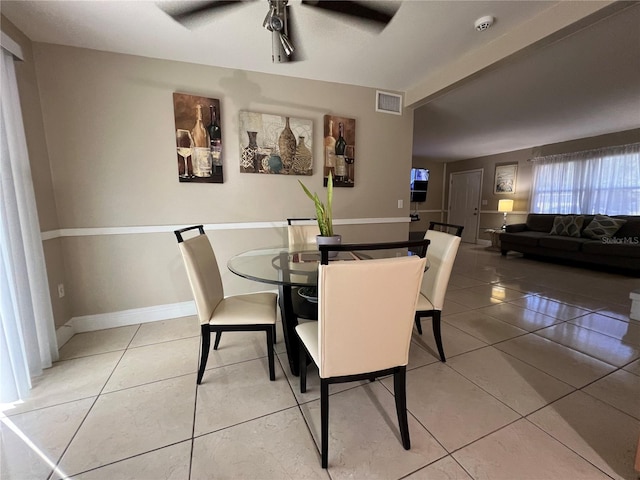 dining area featuring ceiling fan and tile patterned flooring