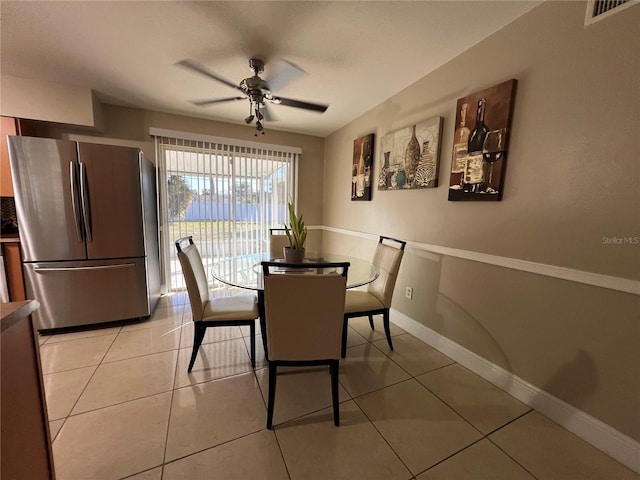 tiled dining area with ceiling fan