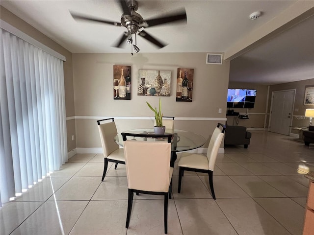 dining area with light tile patterned floors and ceiling fan