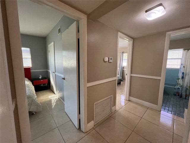 hallway featuring light tile patterned flooring