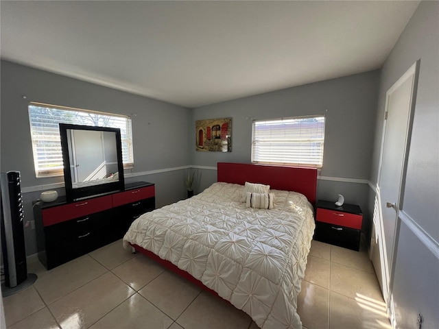 bedroom with light tile patterned floors