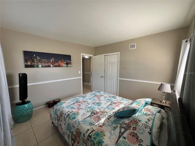 tiled bedroom featuring a closet