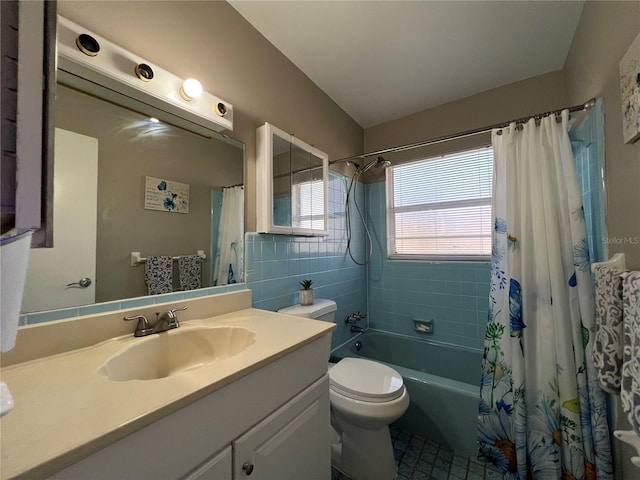 full bathroom with lofted ceiling, tile walls, vanity, toilet, and shower / bath combo with shower curtain