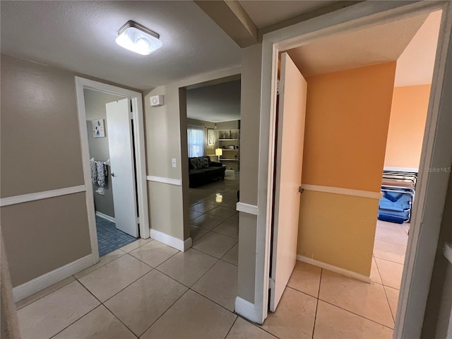 hall with light tile patterned floors