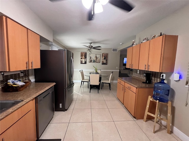 kitchen featuring light tile patterned flooring, appliances with stainless steel finishes, ceiling fan, and decorative backsplash