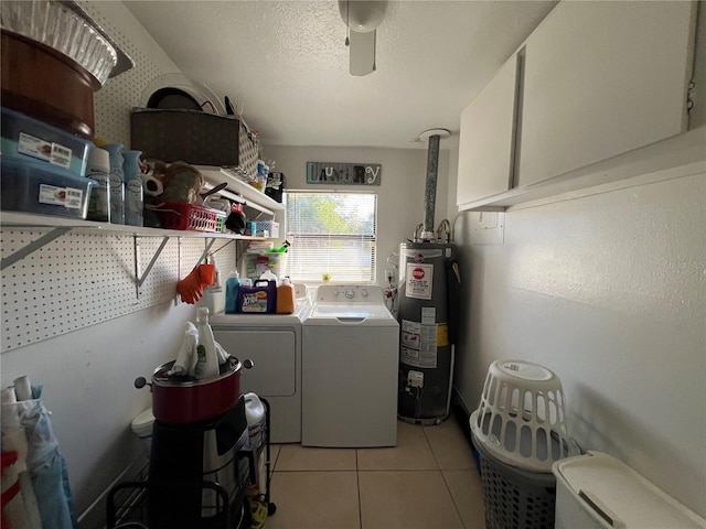 laundry area with gas water heater, light tile patterned flooring, washer and dryer, ceiling fan, and a textured ceiling