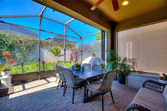 sunroom featuring a ceiling fan