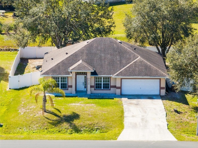 view of front facade featuring a garage and a front lawn