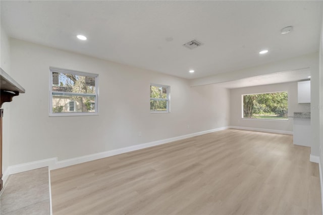 empty room with light hardwood / wood-style flooring