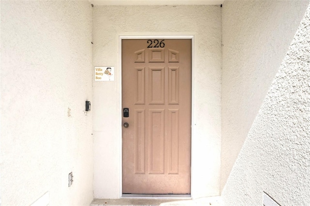 doorway to property with stucco siding