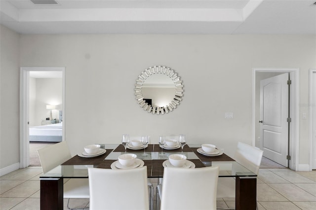 unfurnished dining area with light tile patterned floors and baseboards