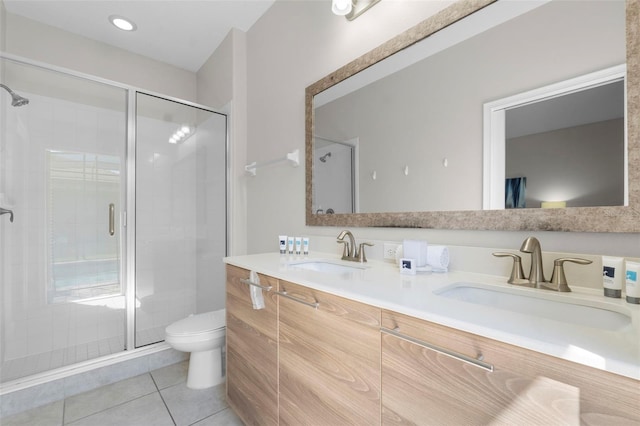 bathroom featuring a stall shower, a sink, and tile patterned floors