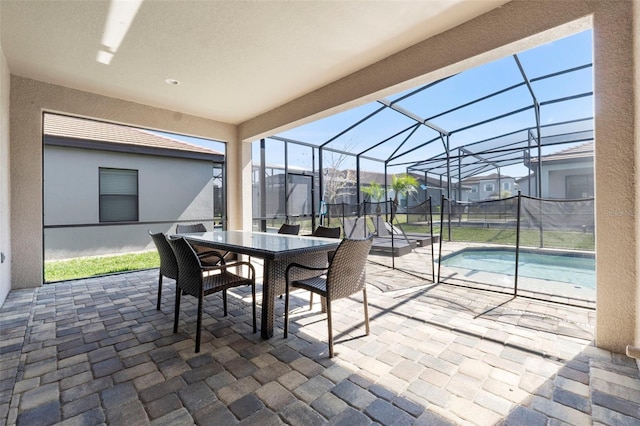 view of patio / terrace with a lanai, outdoor dining area, a residential view, and an outdoor pool