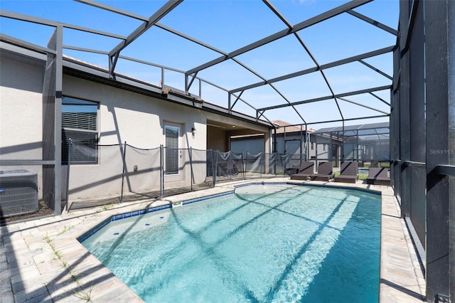 outdoor pool with a patio area and glass enclosure