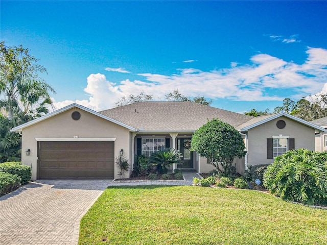 single story home with a garage and a front lawn