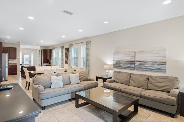 living room with plenty of natural light and light tile patterned floors