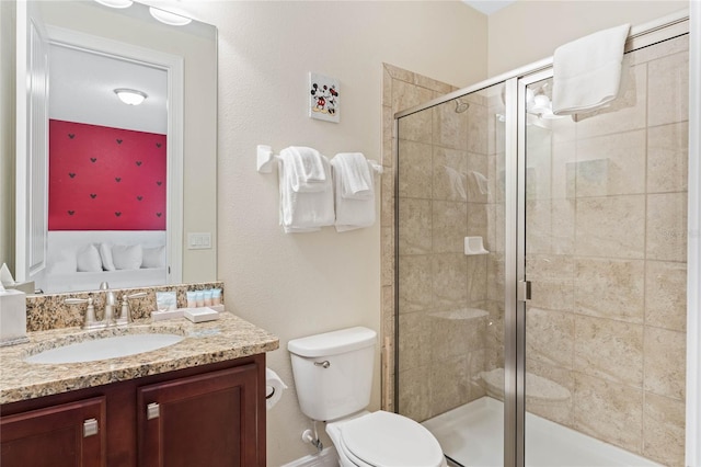 bathroom featuring vanity, toilet, and walk in shower