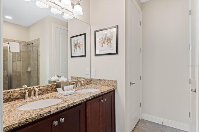 bathroom featuring an inviting chandelier, vanity, a shower with shower door, and tile patterned flooring