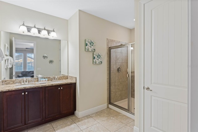 bathroom with tile patterned flooring, vanity, and walk in shower