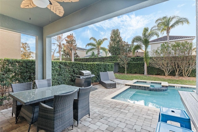 view of pool with a patio area, grilling area, ceiling fan, and an in ground hot tub