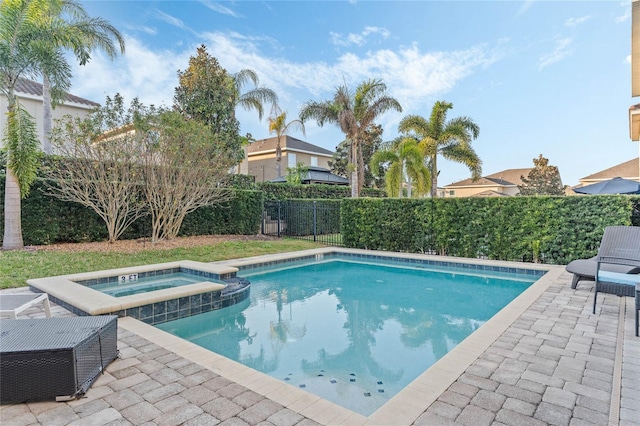 view of pool featuring a patio area and an in ground hot tub