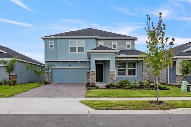 view of front of home with a garage and a front lawn