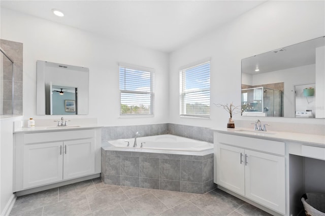 139 Aces High Ln, Davenport, FL 33896 - full bath featuring a shower stall, a garden tub, two vanities, and a sink