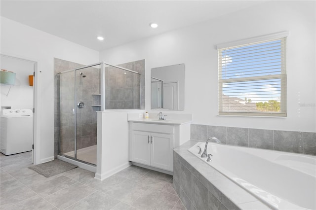 139 Aces High Ln, Davenport, FL 33896 - bathroom with a stall shower, tile patterned floors, washer / clothes dryer, and vanity