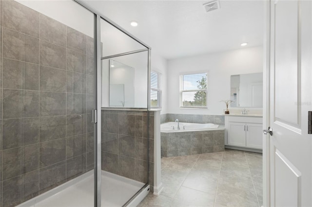 139 Aces High Ln, Davenport, FL 33896 - bathroom featuring a garden tub, visible vents, tile patterned flooring, a shower stall, and vanity