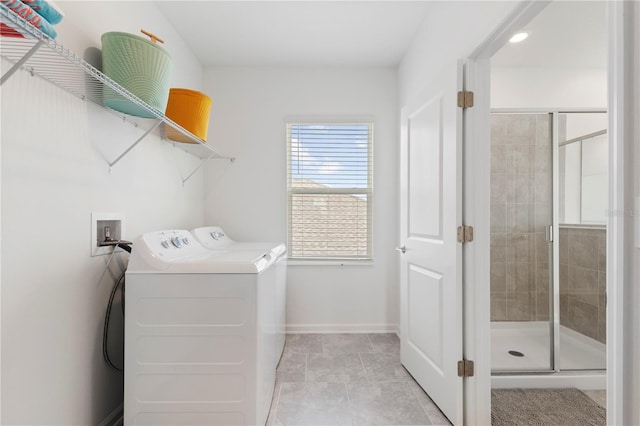 139 Aces High Ln, Davenport, FL 33896 - laundry room with washing machine and dryer, laundry area, light tile patterned flooring, and baseboards