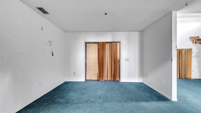 spare room with carpet floors and a textured ceiling