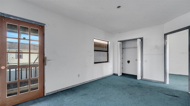 unfurnished bedroom featuring dark carpet
