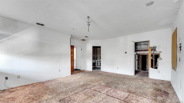 empty room with a textured ceiling