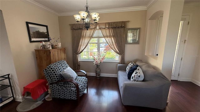 sitting room with ornamental molding, dark hardwood / wood-style flooring, and a chandelier