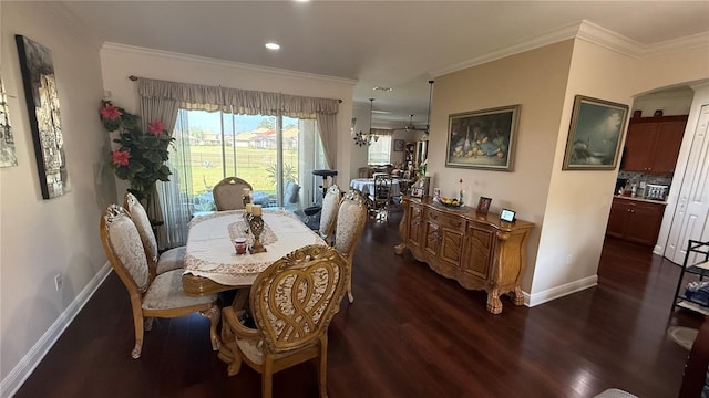 dining area featuring ornamental molding and dark hardwood / wood-style floors