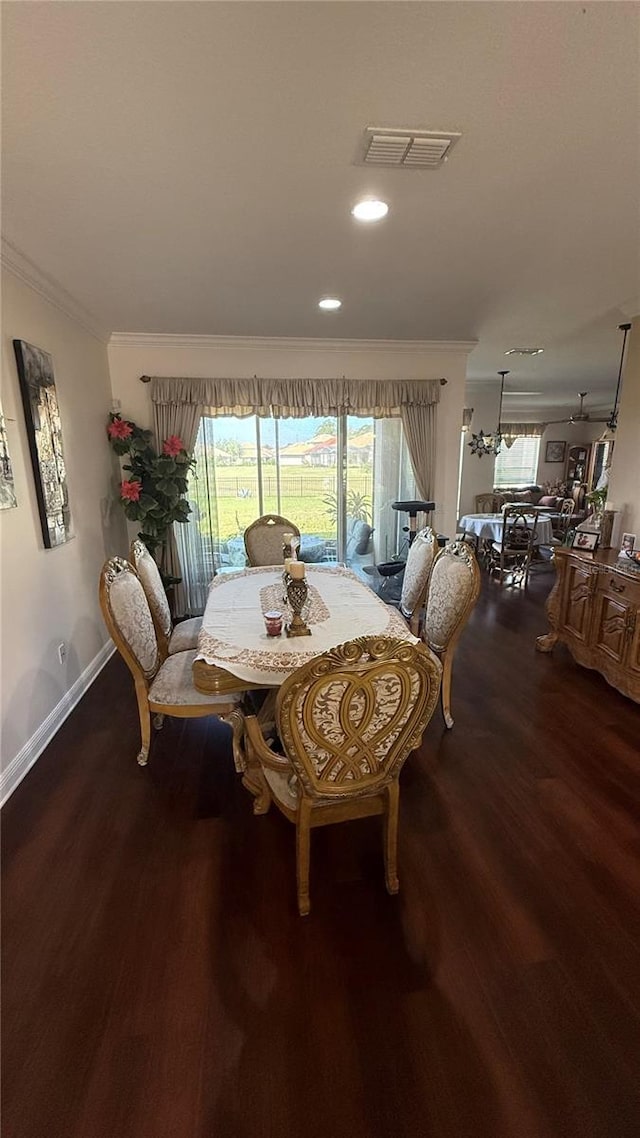 dining room featuring crown molding and hardwood / wood-style flooring