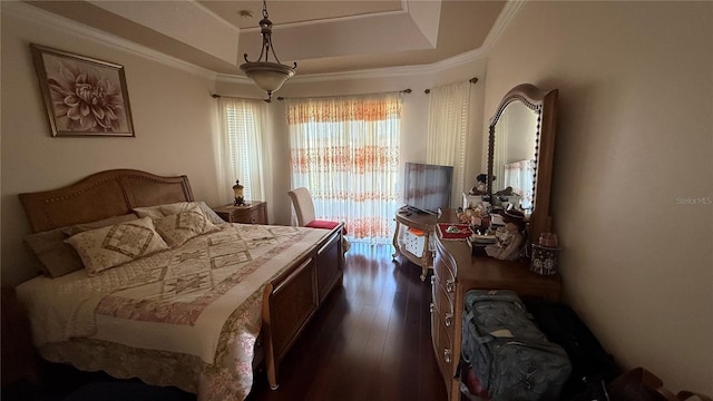 bedroom featuring ornamental molding, dark hardwood / wood-style floors, and a raised ceiling