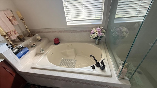 bathroom with a relaxing tiled tub