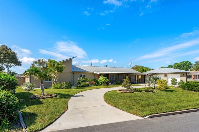 single story home featuring a garage and a front lawn