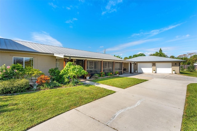 ranch-style house featuring a garage and a front lawn