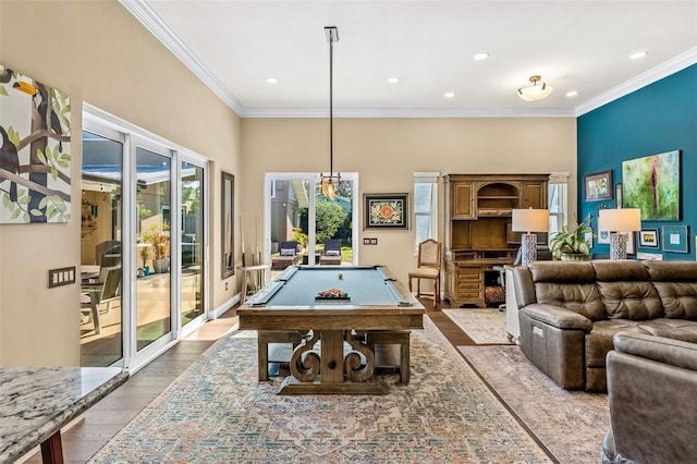 recreation room featuring billiards, ornamental molding, light hardwood / wood-style floors, and a high ceiling