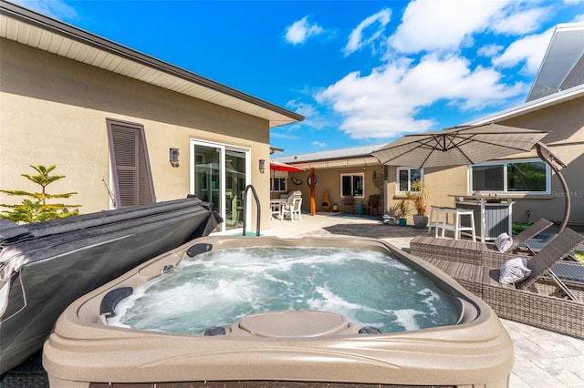 view of pool featuring a patio area and a hot tub