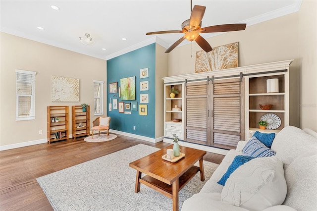 living room with ceiling fan, ornamental molding, and wood-type flooring