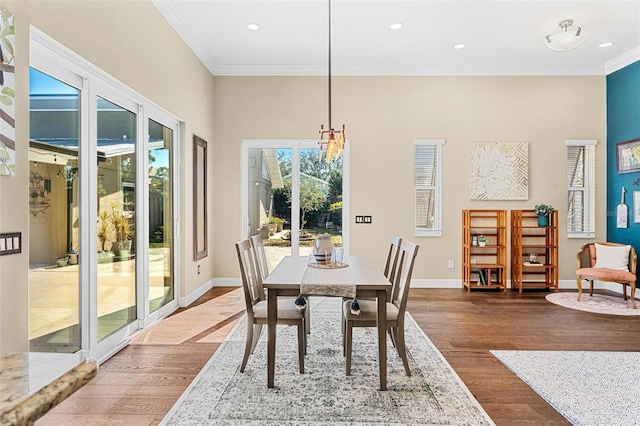 dining room with dark hardwood / wood-style flooring and crown molding