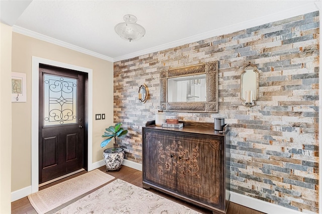 foyer entrance featuring crown molding and dark hardwood / wood-style floors